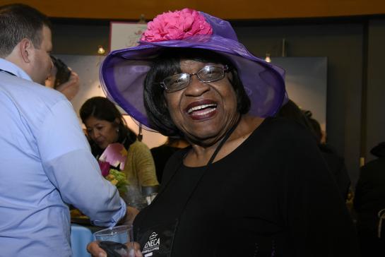 smiling woman in a derby hat